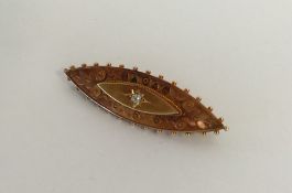 A diamond boat shaped brooch with ball decoration