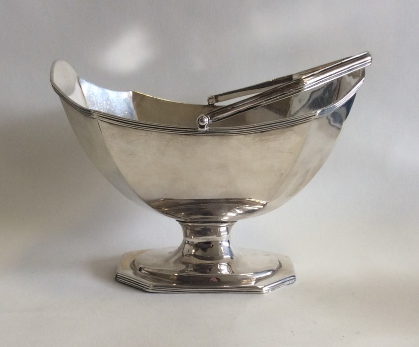 A heavy George III silver swing handled basket of