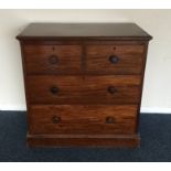 A small mahogany chest of four drawers on plinth b