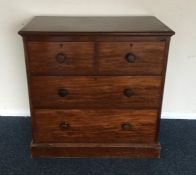 A small mahogany chest of four drawers on plinth b