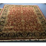 A large Oriental style carpet. Est. £50 - £80.