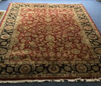 A large Oriental style carpet. Est. £50 - £80.