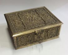 A heavy rectangular brass box decorated with figur