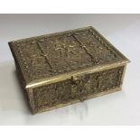 A heavy rectangular brass box decorated with figur