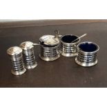 A five piece Edwardian silver cruet with pierced d