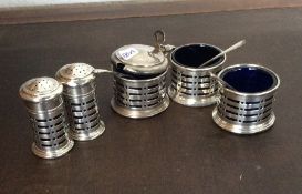 A five piece Edwardian silver cruet with pierced d