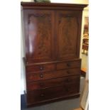 A mahogany five drawer linen press with turned han