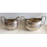 A pair of Georgian style oval silver cream and sug