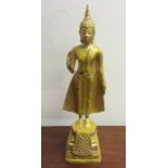 A tall metal figure of a Thai lady wearing Makuta.