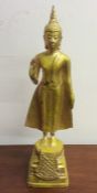 A tall metal figure of a Thai lady wearing Makuta.