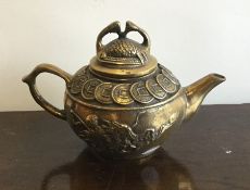 An unusual Chinese brass teapot with lift-off cove