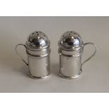 A matched pair of silver pepperettes of churn form