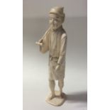 A carved ivory model of an Oriental man in standin