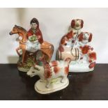 A group of three Staffordshire figures. Est. £25 -