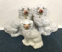 A pair of Staffordshire dogs together with one oth