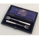 An Edwardian silver tapering spoon and fork contai