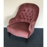 An Edwardian button back nursing chair on turned s