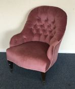 An Edwardian button back nursing chair on turned s