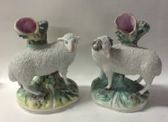 A pair of Staffordshire sheep on green rugged land