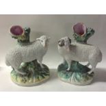 A pair of Staffordshire sheep on green rugged land