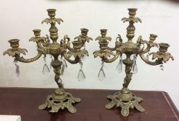 A pair of flamboyant brass and glass mounted candl