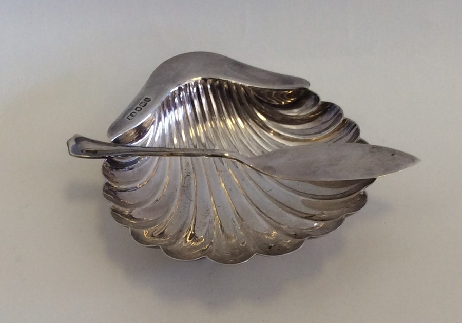 An Edwardian silver butter dish together with matc