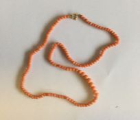 A small string of tapering coral beads. Approx. 8