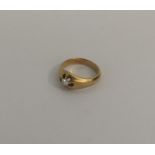 An 18 carat gold diamond single stone gypsy set ri
