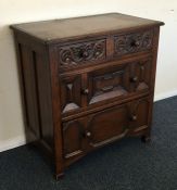 An oak chest of four drawers with panelled sides.