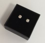 A pair of good diamond single stone ear studs in f