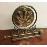 A stylish brass mounted dinner gong on wooden moun