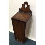 An Antique oak candle box. Est. £20 - £30.