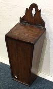 An Antique oak candle box. Est. £20 - £30.