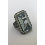 A massive aquamarine and diamond cluster ring, the