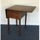 A Victorian two drawer drop leaf table on tapering