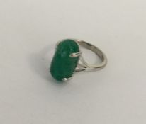 A cabochon emerald single stone ring in claw mount