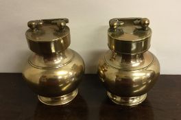 A pair of Oriental brass canisters with screw-on c