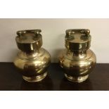A pair of Oriental brass canisters with screw-on c