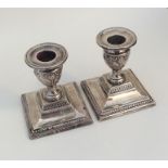 A pair of Edwardian silver piano candlesticks on s