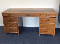 A large nine drawer twin pedestal desk with cast h
