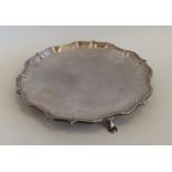 An Edwardian silver waiter with shaped border. She