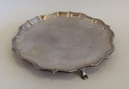 An Edwardian silver waiter with shaped border. She