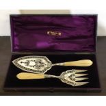 A good Victorian boxed pair of silver fish servers