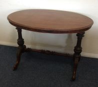 A Victorian oval table with turned supports. Est.