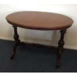 A Victorian oval table with turned supports. Est.