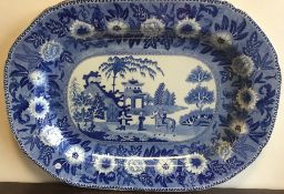 A large blue and white meat plate decorated with f