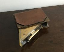 An unusual brass mounted lighter in the form of a