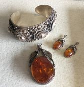 A Continental silver bangle together with an amber