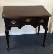 A Georgian mahogany three drawer lowboy with brass