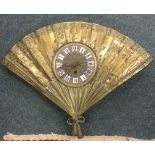 An unusual brass mounted wall clock in the form of